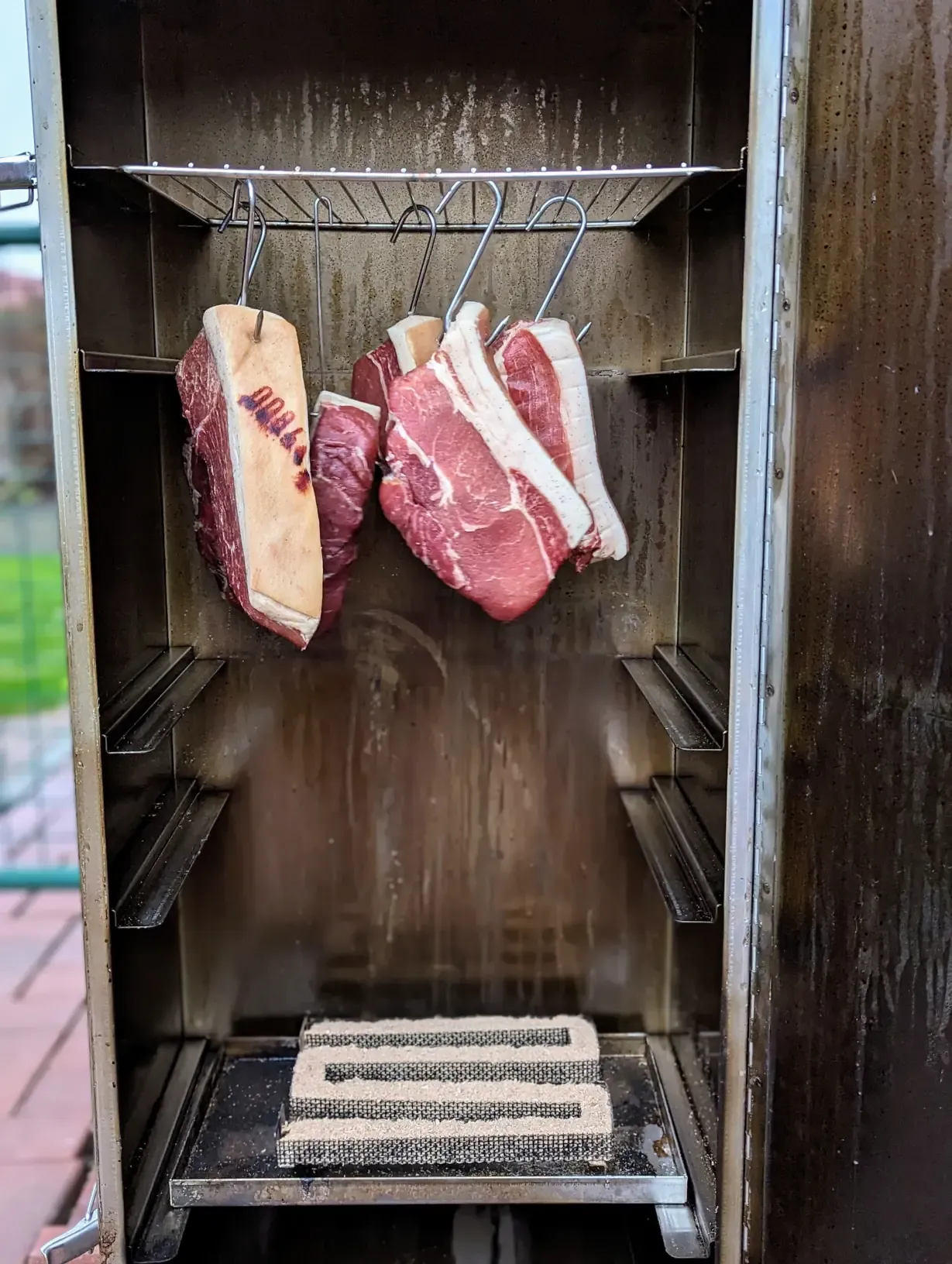 meat hanging in a smoker