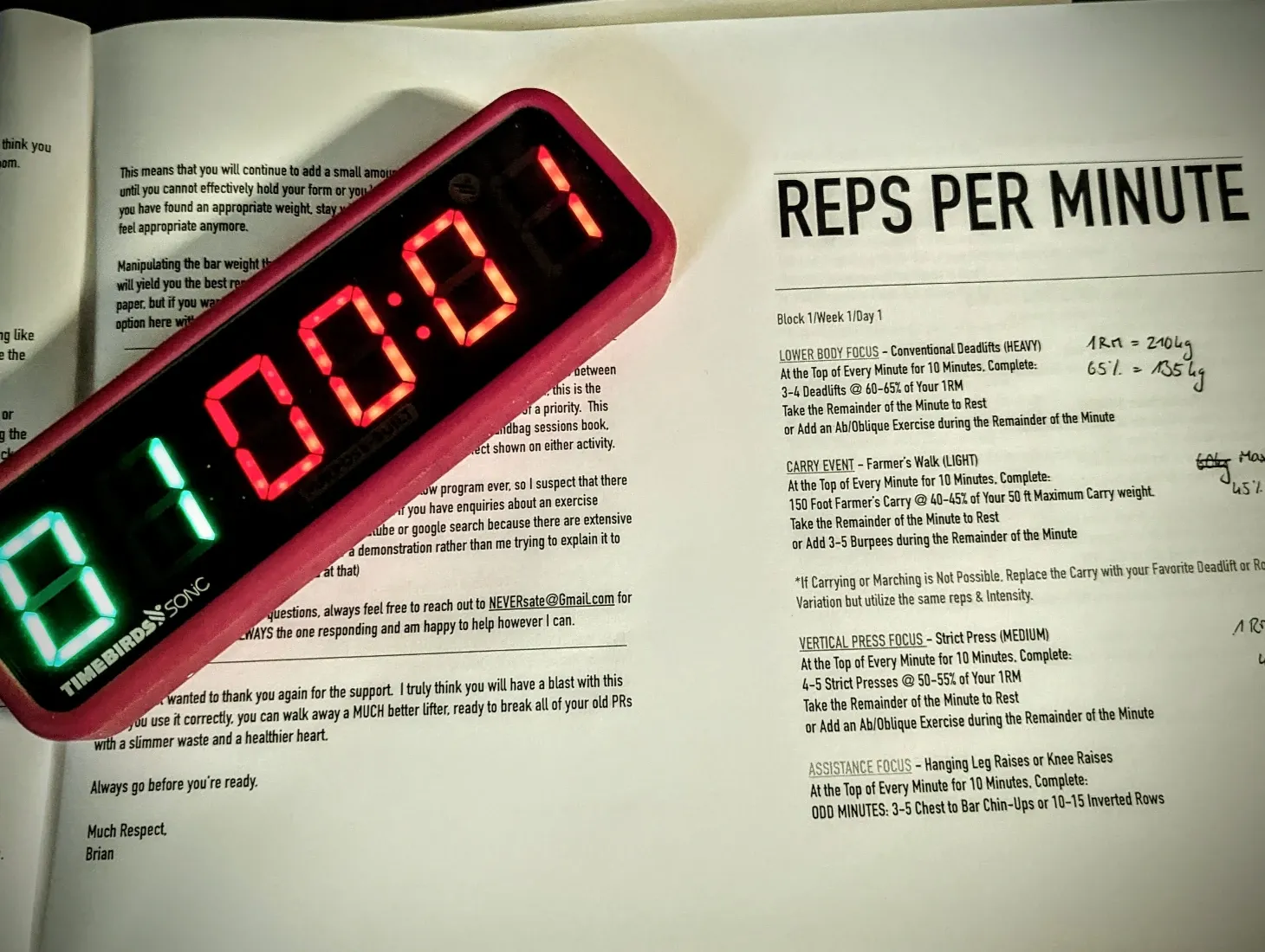 gym timer sitting on top of the printed out workout program for the day